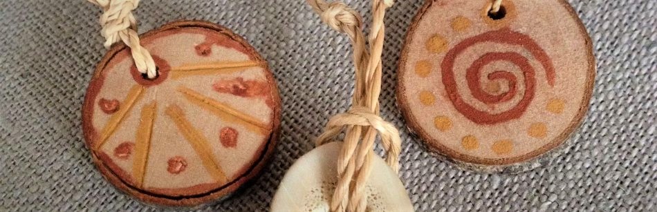 amulets of wood and antler painted with ochre